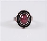 Lot 2577 - A star ruby ring, the oval star ruby cabochon,...