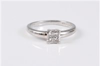 Lot 2640 - A platinum and diamond ring, the four princess...