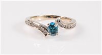 Lot 1297 - A blue and white diamond ring, the...