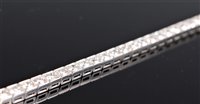 Lot 1245 - A diamond line bracelet, the round brilliant...