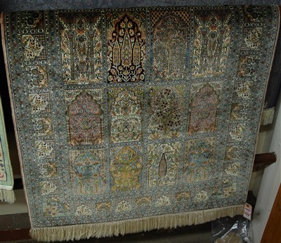 Lot 1142 - A Persian woven silk rug, having five rows of...