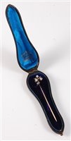 Lot 2501 - A diamond stick pin: the three round old cut...