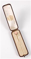 Lot 2504 - A coral and diamond stick pin: the round coral...