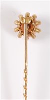 Lot 2504 - A coral and diamond stick pin: the round coral...