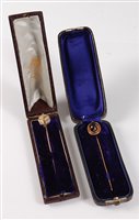 Lot 2505 - Two stick pins: the first set with a garnet...