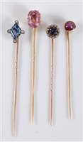 Lot 2509 - Four gemset stick pins: to include a pink...