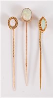 Lot 2510 - Three opal stick pins: to include a marquise...