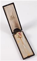 Lot 2516 - A painted ivory stick pin: the oval ivory...