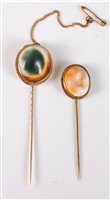 Lot 2517 - Two operculum stick pins: the oval operculum...