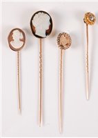 Lot 2531 - Three cameo stick pins and a diamond stick pin:...