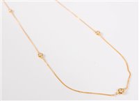 Lot 1278 - A 14ct diamond set long chain, the round...
