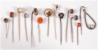 Lot 2561 - Thirteen assorted stick pins: to include...