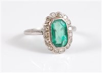 Lot 1260 - A platinum emerald and diamond ring, the...