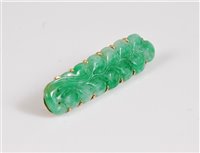 Lot 1286 - A jade brooch, the jade carved as a sprig of...