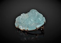 Lot 1284 - A Chinese carved aquamarine brooch, the off...