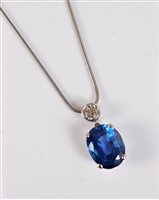 Lot 1254 - A sapphire and diamond pendant, the oval mixed...