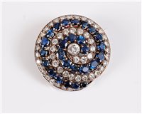 Lot 1298 - A sapphire and diamond spiral brooch, the...