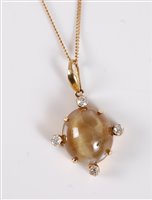Lot 1314 - An 18ct cats eye chrysoberyl and diamond...