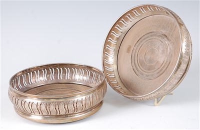 Lot 1192 - A pair of modern silver wine coasters, having...