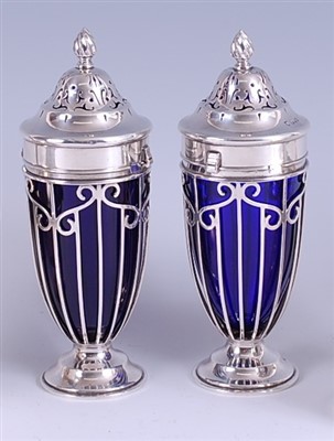 Lot 1207 - A pair of Edwardian silver sugar casters, each...
