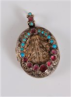 Lot 2666 - A gemset locket, the oval engraved locket set...
