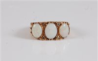 Lot 2594 - A 9ct opal and diamond ring, the three oval...