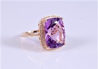 Lot 1294 - A 14k amethyst and diamond ring, the mixed cut...