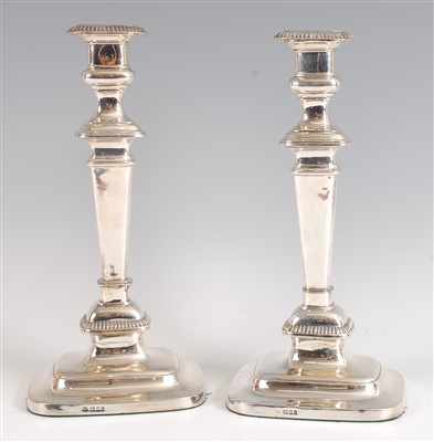 Lot 1213 - A pair of George V silver table candlesticks,...