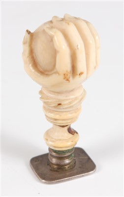 Lot 1355 - A 19th century carved ivory fist and ball seal,...