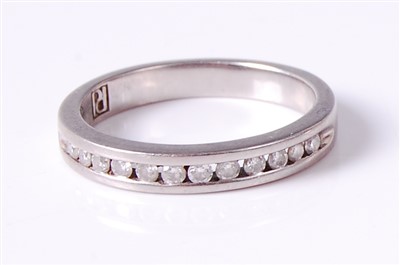 Lot 2673 - A palladium and diamond set half-hoop eternity,...