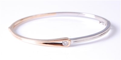 Lot 2678 - A contemporary 9ct yellow and white gold hinge...