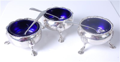 Lot 1157 - A matched set of three George III silver table...