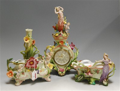 Lot 3 - A German porcelain cased mantel clock, having...
