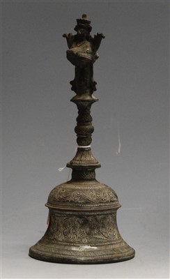 Lot 20 - A Tibetan brass hand-bell, having all-over...