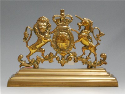Lot 22 - A brass door-stop, with central crowned garter...