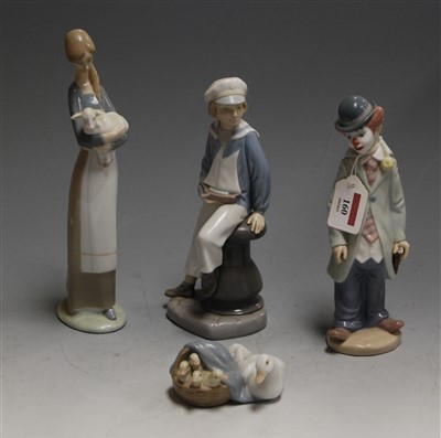 Lot 160 - A Lladro figure of a young boy, in seated pose...
