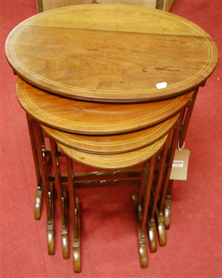 Lot 1224 - A mahogany and satinwood strung oval nest of...