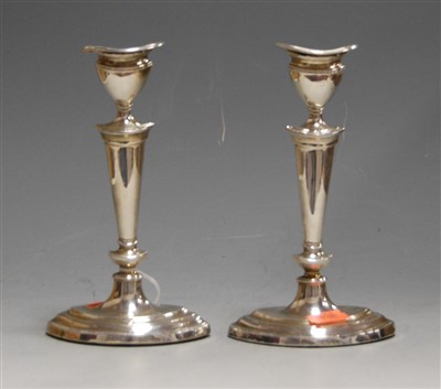 Lot 194 - A pair of George V silver table candlesticks...