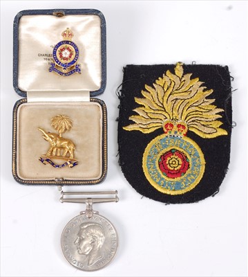 Lot 16 - A West African Frontier Force gold and enamelled sweetheart brooch