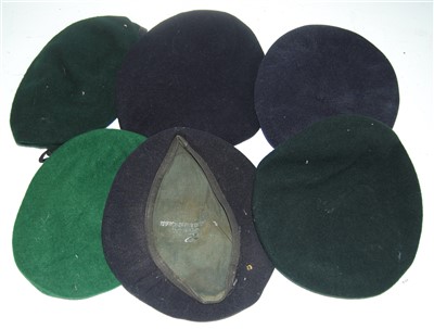 Lot 244 - A blue felt beret, stamped British Beret Badge...