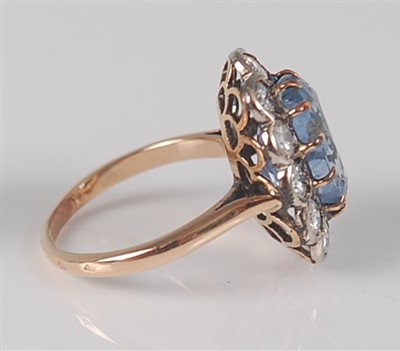 Lot 1174 - A sapphire and diamond oval cluster ring, claw...