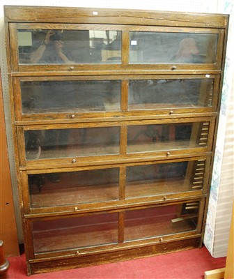 Lot 1107 - A 1930s oak five-tier stacking bookcase,...