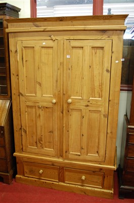 Lot 1129 - A reclaimed pine double door wardrobe, having...