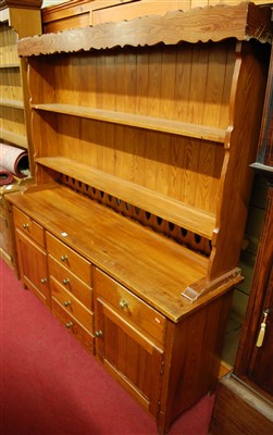 Lot 1159 - A modern stained pine kitchen dresser, w.172cm
