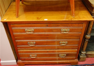 Lot 1170 - An Edwardian walnut chest, of three long...