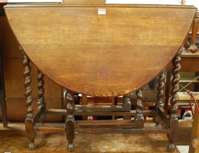 Lot 1172 - An early 20th century oak barleytwist gateleg...