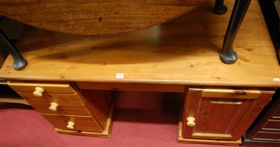 Lot 1219 - A modern pine kneehole desk, having four...
