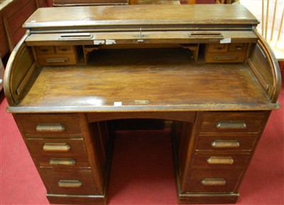 Lot 1227 - An early 20th century oak rolltop kneehole...