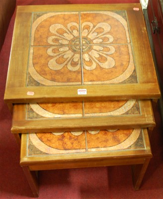 Lot 1239 - A 1970s teak and tile top inset nest of three...