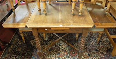Lot 1258 - A 1930s oak barley twist draw leaf dining...